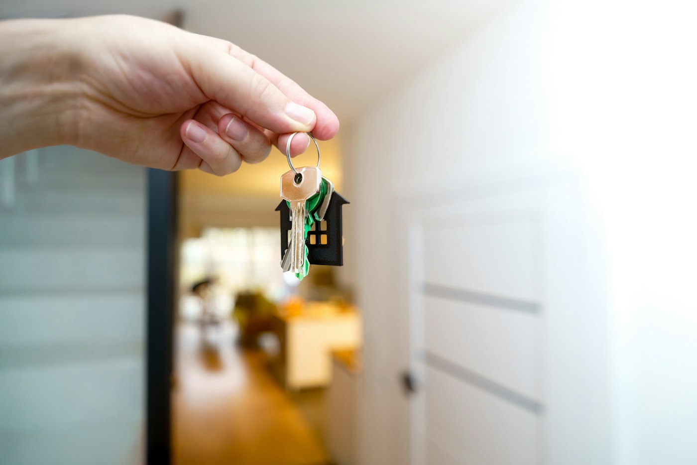 SPV’s & SPV MORTGAGES 2 Hand holding house keys at the entrance of a newly purchased home